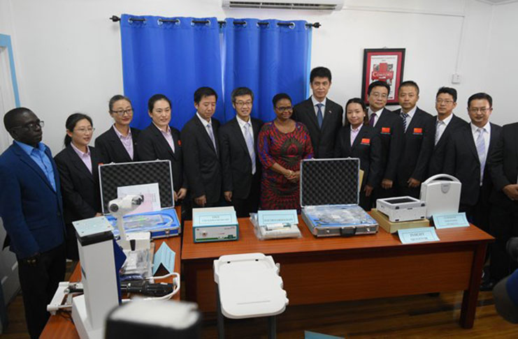Minister of Public Health, Volda Lawrence flanked by members of the 14th Chinese Medical Brigade with samples of the equipment which had been handed over