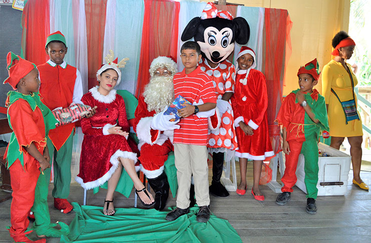 Children sharing smiles and laughter with Mr. and Mrs. Claus