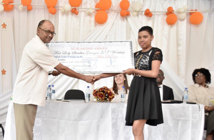 Best Graduating Student and Valedictorian Ms. Atika DeJonge receives her scholarship from Chairman of the BIT Board of Guardians Mr. Deleep Singh at the graduation ceremony