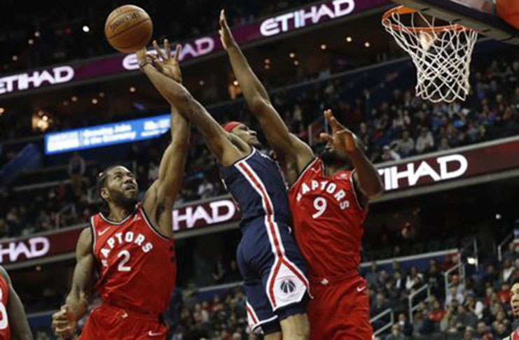 Washington, DC, USA; Washington Wizards guard Bradley Beal (3) is fouled while shooting the ball by Toronto Raptors forward Serge Ibaka (9) in overtime at Capital One Arena. The Raptors won 140-138 in double overtime. Mandatory Credit: Geoff Burke-USA TODAY Sports