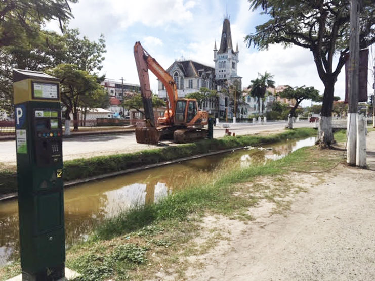 From left, one of the controversial Parking Meters, the Avenue of the Republic canal, a piece of heavy-duty equipment and in the background, the deteriorating City Hall (Photo by F.Q. Farrier - 2018)
