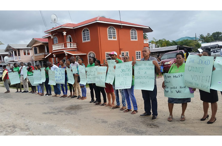 Residents of Bartica with Regional Chairman Gordon Bradford and Mayor Gifford Marshall, protesting at the GECOM Office on First Street, Bartica