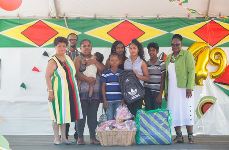 Minister Amna Ally (first left) and REO Jennifer Ferriera-Dougall (first right) make their presentations to the Roberts family