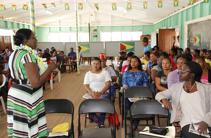 Minister of Education Nicolette Henry interacting with children, teachers and parents of Ituni (Ministry of Education photo)