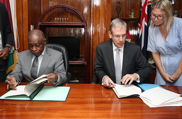 Vice President and Foreign Affairs Minister Carl Greenidge and High Commissioner Designate of New Zealand to Guyana Anton Ojala, sign the air services agreement