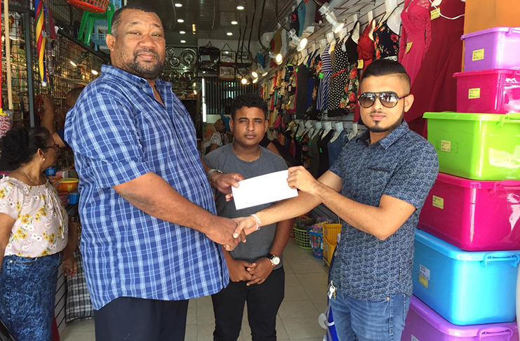 Ryan Singh hands over sponsorship to BCB president Hilbert Foster in the presence of PRO Simon Naidu.