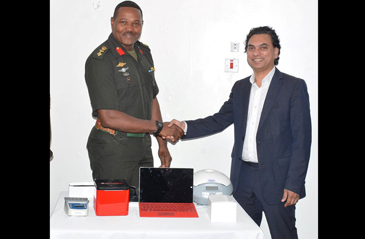 Acting Chief of Staff, Colonel Trevor Bowman received the equipment from Alan Zaakir, a member of the diaspora