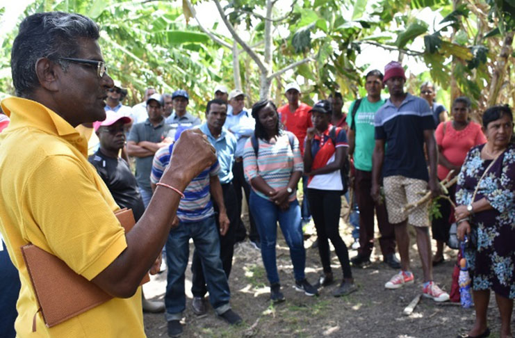 GMC officials flanked by farmers during the visit