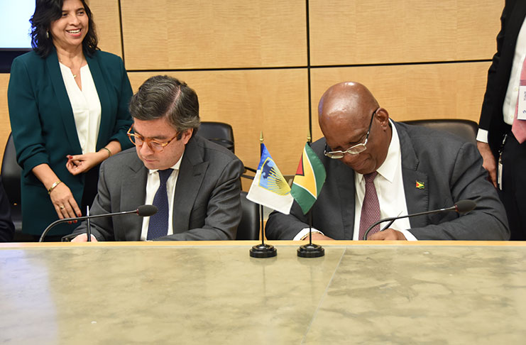 Finance Minister Winston Jordan and IDB President Mr. Luis Alberto Moreno signing the loan agreement