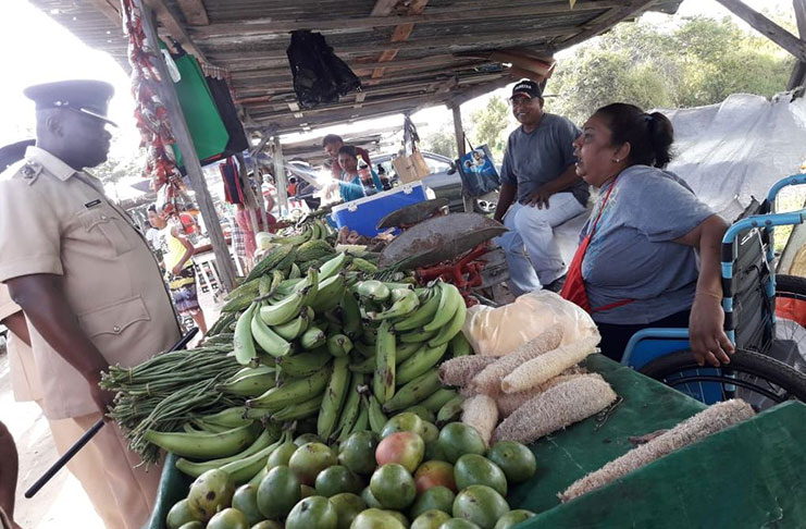 Commander, Senior Superintendent Edmond Cooper listens to the concerns of a vendor during the walkabout