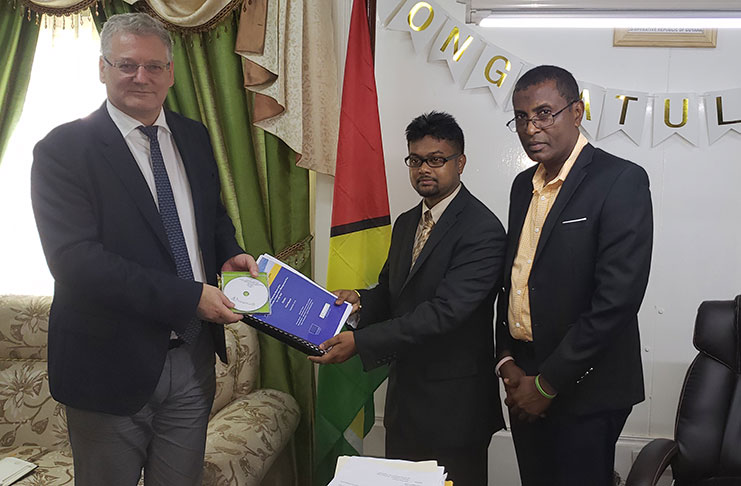 Mayor of Georgetown, Pandit Ubraj Narine receives copies of the plan from EU Ambassador to Guyana, Jernej Videtic in the presence Deputy Mayor Alfred Mentore