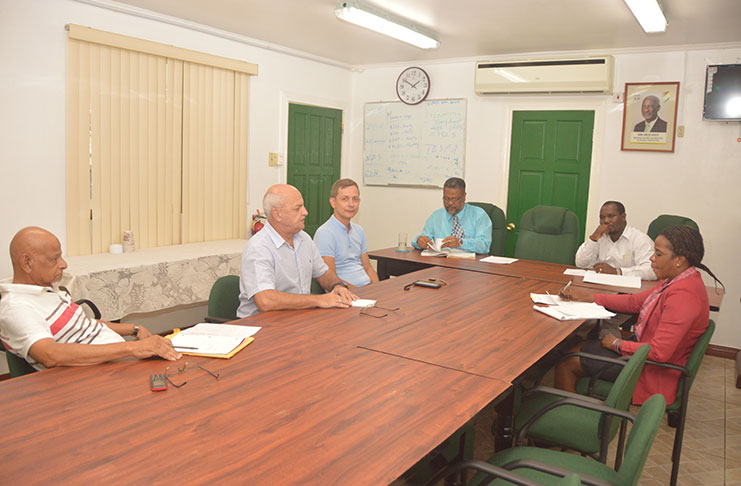 BCGI representatives (from left) Mohamed Akeel; Vladimir Permyakov, and Personnel Manager Mikhail Krupenin, meeting with Chief Labour Officer, Charles Ogle (fourth from left) and other Department of Labour representatives (Adrian Narine photo)