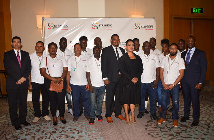 Chief Executive Officer (CEO) Kerri Gravesande-Bart with Guyanese workers who have benefitted from the SRS (Adrian Narine photo)