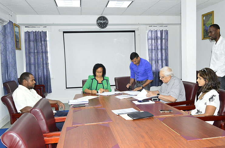 MoE Permanent Secretary, Adele Clarke, (centre) signing the $114M contract