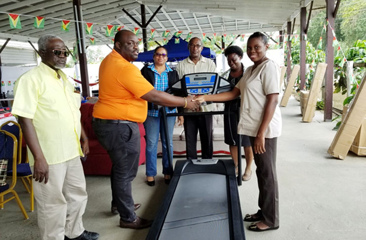 Director of Regional Health Services of Region 6, Jevaughn Andrew Stephen handing over the treadmill to a doctor attached to the physiotherapy department. Looking on are Regional Executive Officer, Kim Williams-Stephen; Focal Point Coordinator and Adviser to the Minister of Public Health, Alex Foster, and Matron of the New Amsterdam Hospital.