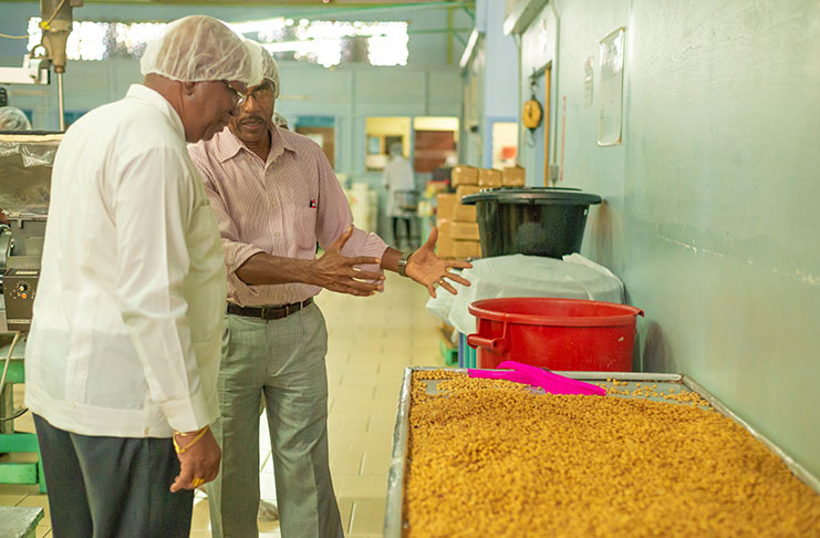 Finance Minister Winston Jordan in
discussion with Tandy’s Manufacturing
Director, Burt Denny during a tour of the
East Bank Demerara business on Monday
(Delano Williams photo)