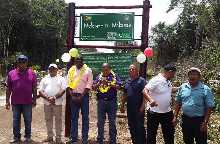 Public Infrastructure Minister David Patterson flanked by Region Two Regional Executive Officer (REO) (left) and Minister of Indigenous People’s Affairs Sydney Allicock (right) with regional officials at the bridge commissioning (Indrawattie Natram photo)