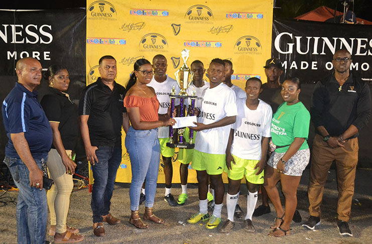 2019 winners of the Berbice Guinness ‘Greatest of the Streets’ leg, Trafalgar, receives the championship trophy from a Banks DIH representative. Also in the photo are Guinness Brand Manager, Lee Baptiste (right); Berbice Brand Manager, Bradford Peterken (left) and other Banks DIH staff. (Colin Bynoe Jr Photo)