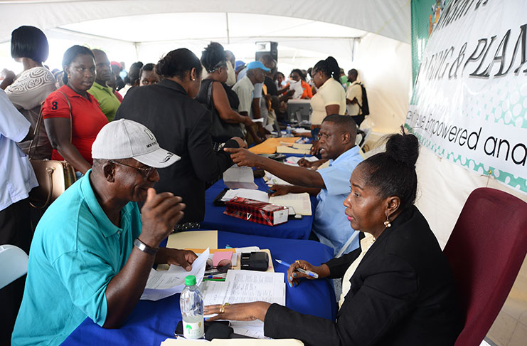 Junior Minister of Communities, with responsibility for housing, Valerie Patterson-Yearwood engaging one resident at the Public Day