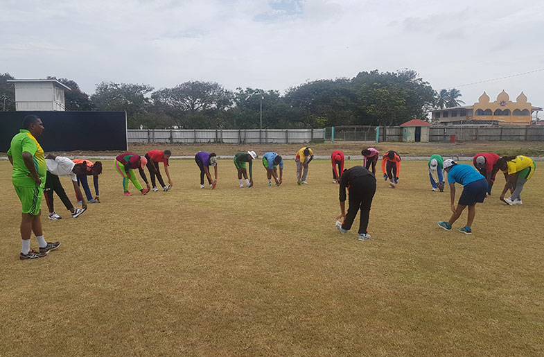 Coach Bharat Mangru looks on as the National female senior cricketers go through their paces during training session yesterday.