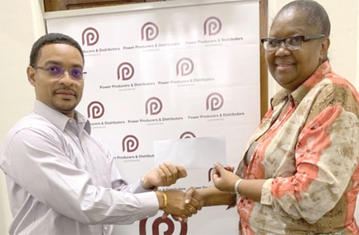 PPDI’s Deputy Chief Executive Officer (Administration) and Human Resources Gary Hall presents a cheque for an undisclosed sum to GTTA’s treasurer Deirdre Edghill.
