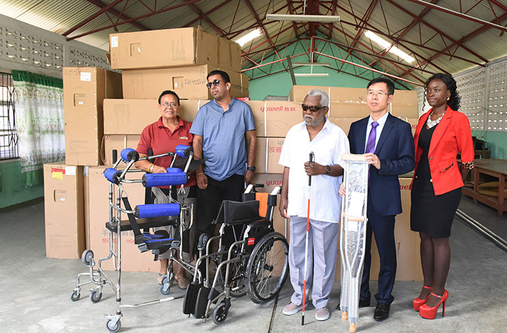 Chen Xilai (second from right) making the presentation to members of the disability community on Friday.