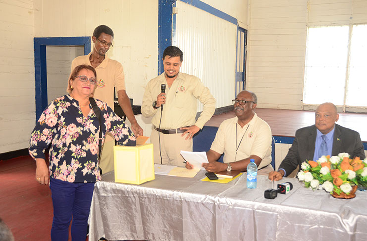 Minister of Natural Resources (first from right) and GGMC Commissioner, Newell Dennison (second from right) along with other officials, look on as a miner partakes in the lottery exercise (Adrian Narine photo)