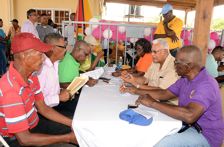 Agriculture Minister Noel Holder (right, centre) interacting with the public on Thursday (Adrian Narine photo)