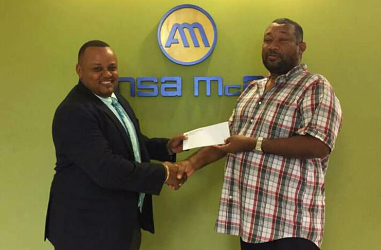 Ansa McAl CEO Troy Cadogan hands over sponsorship to BCB president Hilbert Foster.