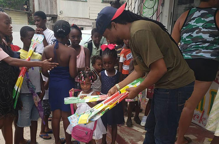 Member of Parliament Jermaine Figueira taking part in a massive kite distribution in communities in Linden