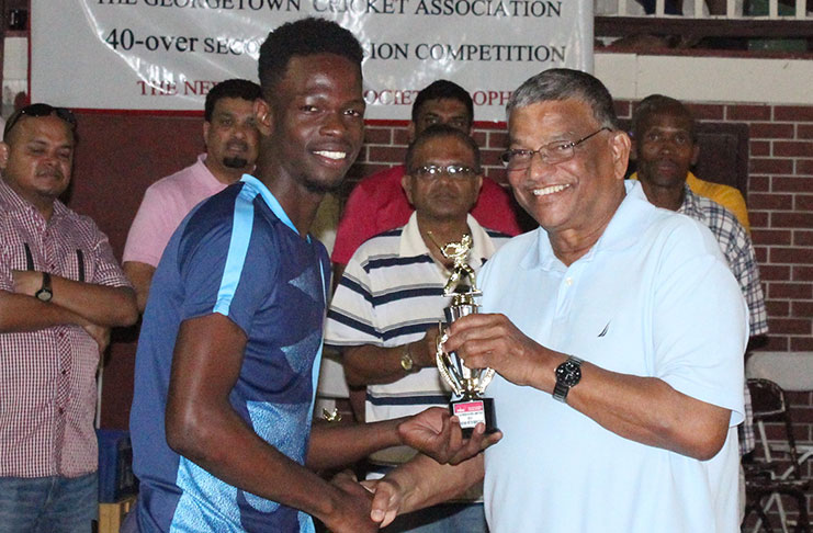 Winston Forrester collects his Man-of-the-Match award from Director of NBS, Dr. Nanda Gopaul.