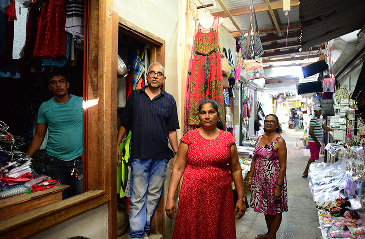 Roberto Tiwari with his son (left), his wife (right) and another female vendor