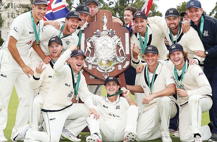 Victorian players pose with the Sheffield Shield trophy after their win during day four of the Sheffield Shield Final. (Photo by Michael Dodge/Getty Images)