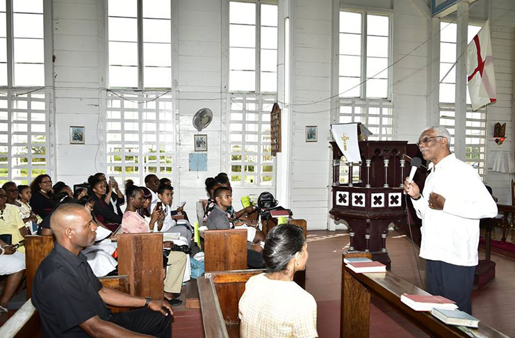 President David Granger speaks to the congregation of St. Matthew's Parish Church, Providence, East Bank Demerara as his daughter, Han Granger- Gaskin (right) looks on (Ministry of the Presidency photo)
