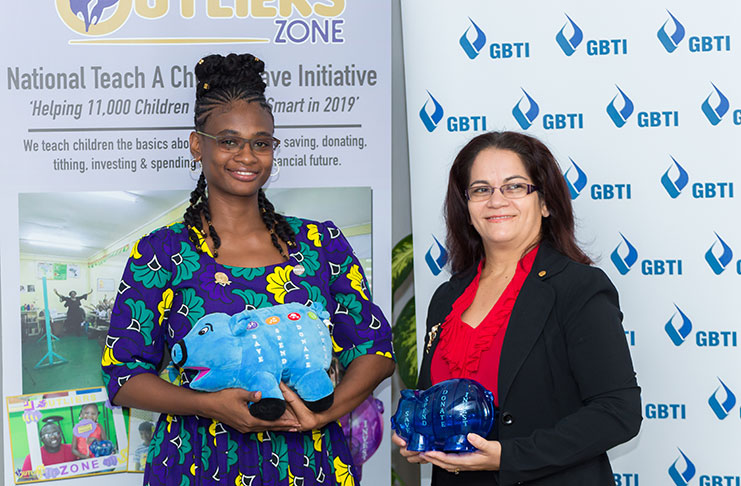 CEO of Outliers Zone, Athalyah Yisrael (at left) with GBTI’s Manager of New Accounts Frances Sahadeo. (Delano Williams photo)