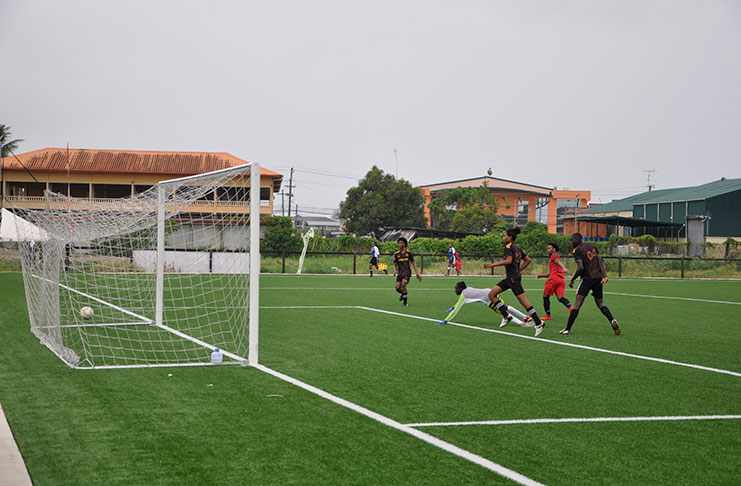 Tyrone Khan (2nd right) scores one of his three goals against Diamond United at the GFF National Training Centre, Providence, EBD.