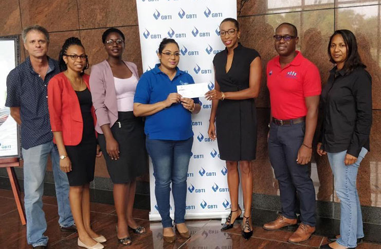 GBTI’s Public Relations Marketing Manager, Pamela Binda, hands over the sponsorship cheque to vice-president Cristy Campbell as other GLTA executives look on.