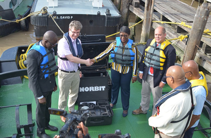 British High Commissioner Greg Quinn hands over one of the sets of hydrographic equipment to MARAD Director-General Claudette Rogers