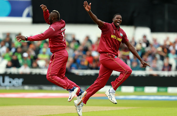 Jason Holder and Andre Russell celebrate Imad Wasim's wicket. (Getty Images)