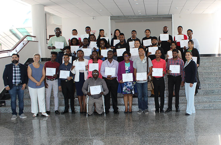 Minister Cathy Hughes; MoPT’s Web Services Coordinator, Jaime Skeete, and Roxana Widmer-Ilescu, ITU Senior Programme Officer, alongside the trainers