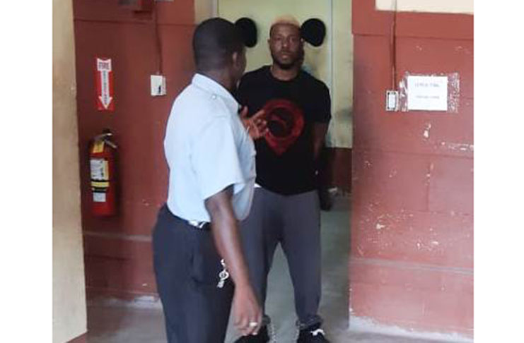 The accused as he was led to the courtroom on Friday.