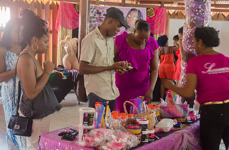 Patrons checking out haircare products at the Carnival Market held at the Umana Yana (Delano Williams photo)
