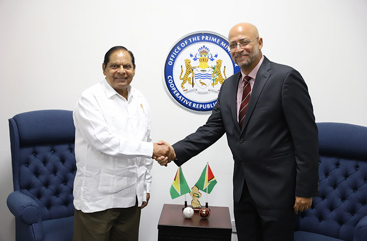 CWI president Ricky Skerritt (at right) greets Prime Minister Moses Nagamootoo. (Keno George photo)