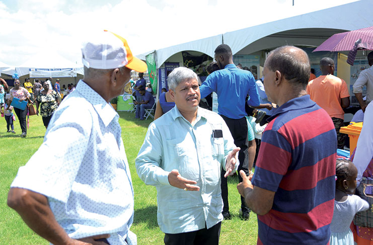Junior Finance Minister, Jaipaul Sharma, speaks with pensioners still awaiting land titles from GySuCo (Samuel Maughn photo)