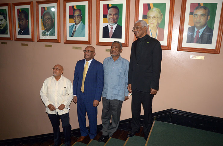 President David Granger and former Presidents Samuel Hinds, Bharrat Jagdeo and Donald Ramotar standing in front of the “Gallery of Presidents.”