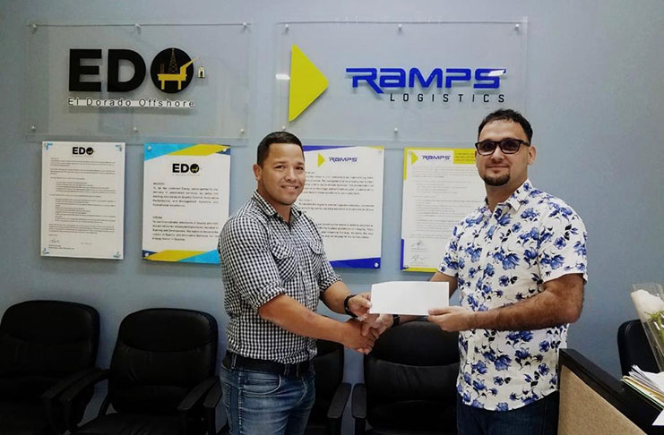 Ramps Logistics Operations Director Richard DeNobrega (right) makes his company’s contribution towards the Guyana Carnival Sevens to Pepsi Hornets’ Ryan Gonsalves.
