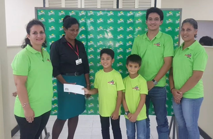 Pure Racing’s Justin Ten-Pow collects the Sprite sponsorship from Banks DIH’s Jennifer Khan.