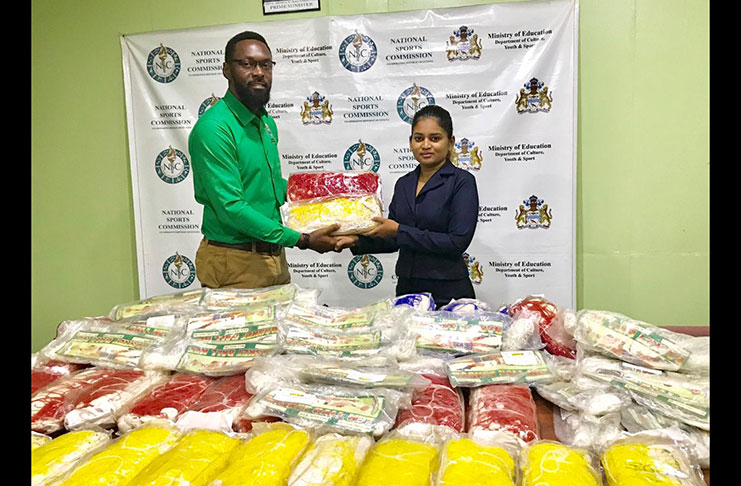 Director of Sport, Christopher Jones, accepts the donation from Silvie’s Sales Manager Naressa Nabby.