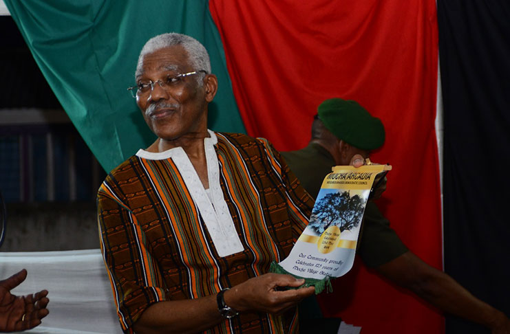 Residents of Mocha-Arcadia residents presenting  the President with fresh produce and a scroll depicting ‘The Big Tree’ where the villages’ early ancestors used to meet (Samuel Maughn photo)