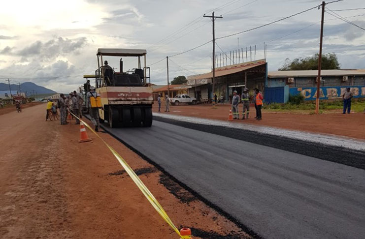 Asphalted paving begins on Lethem Road. Some 100 metres of road selected for sample application of asphalt (DPI photo)